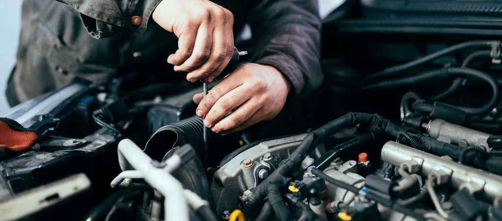 Auto mechanic performing car diagnostics